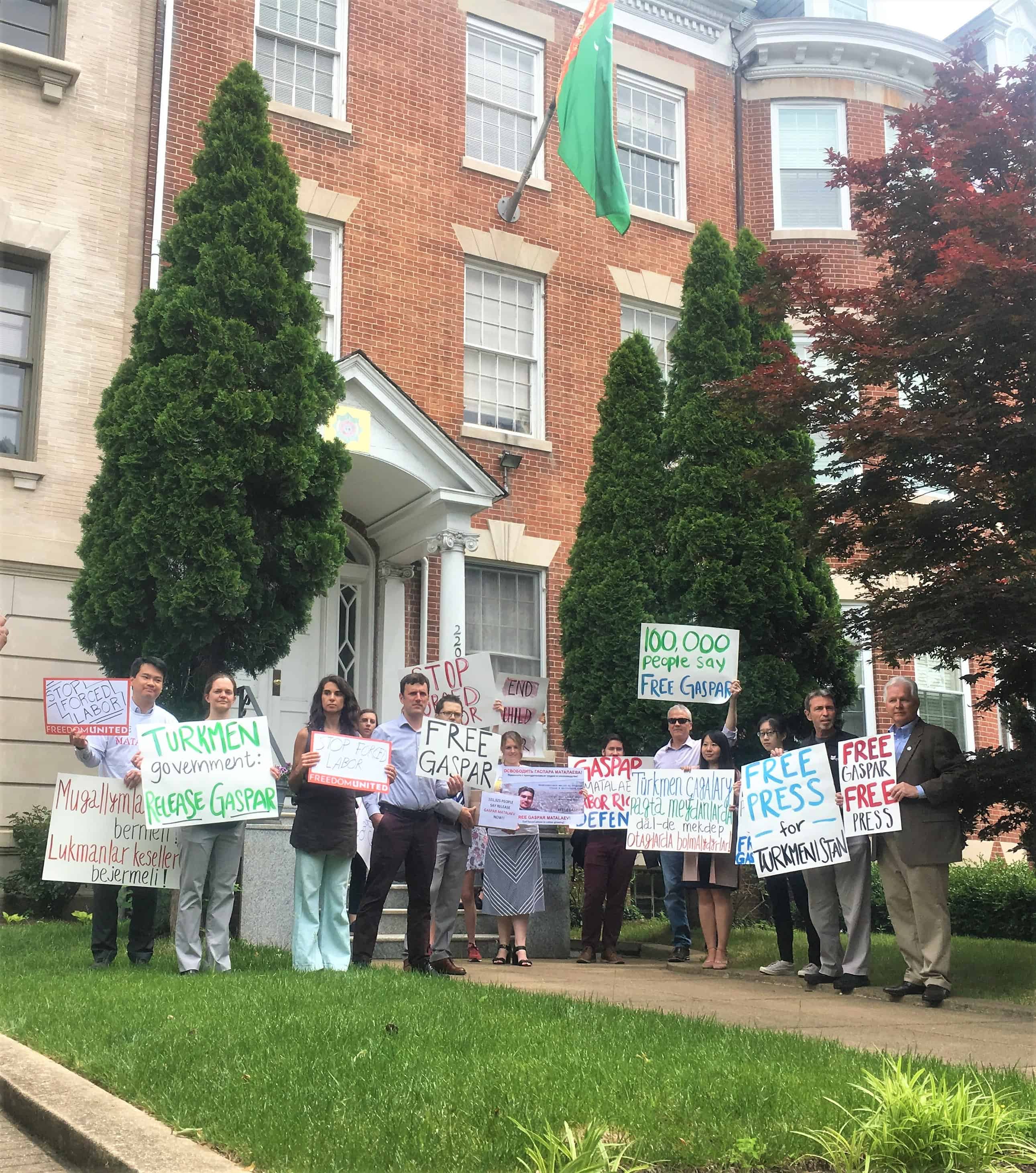 Supporters hold signs outside Embassy of Turkmenistan, DC