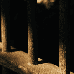 Dark jail cell bars in shadow