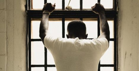 Man standing at window - detention