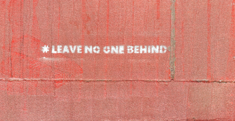 Words #leave no one behind painted on side of building