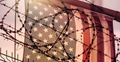 U.S. flag behind barbed wire
