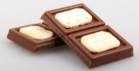 Four pieces of chocolate with cookie inside of them, one half on top of the other
