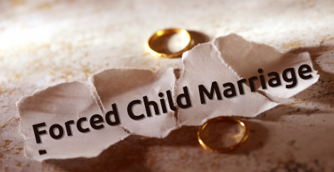Forced child marriages written on a crumbled piece of paper with two rings next to it
