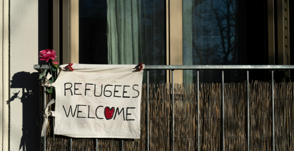 refugees welcome sign hanging on terrace