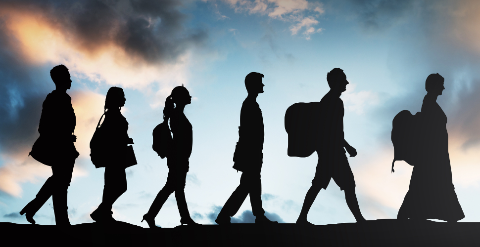 The shadows of 6 persons walking in a line representing modern slavery survivors