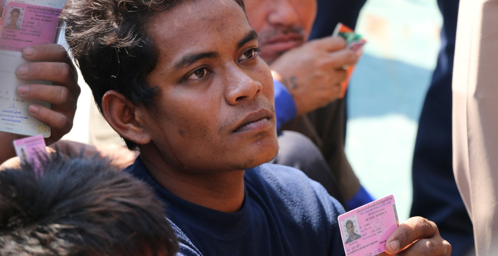 Man holding a piece of I.D.