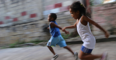 Two children running on the street