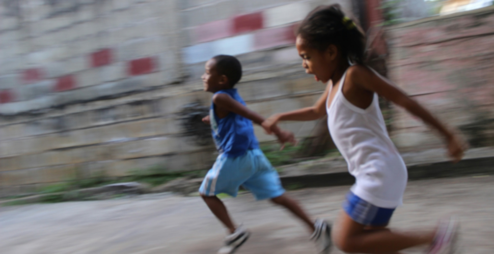 Two children running on the street