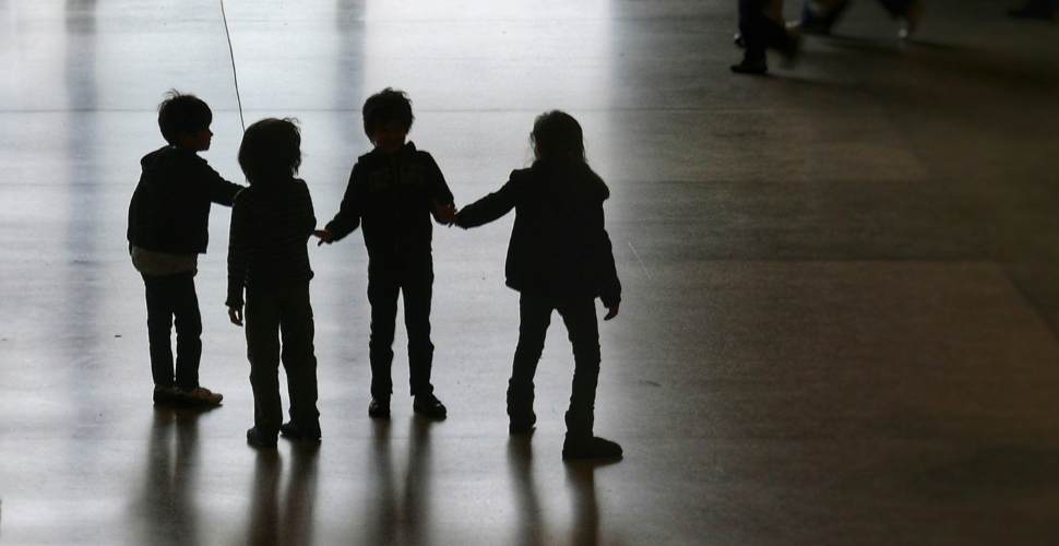 silhouette of four young kids