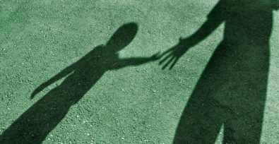 shadow of adult reaching for child