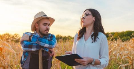 farmer and auditor in field